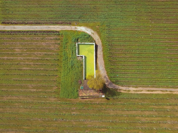 Aerial view of a modern agricultural research facility surrounded by lush green fields.