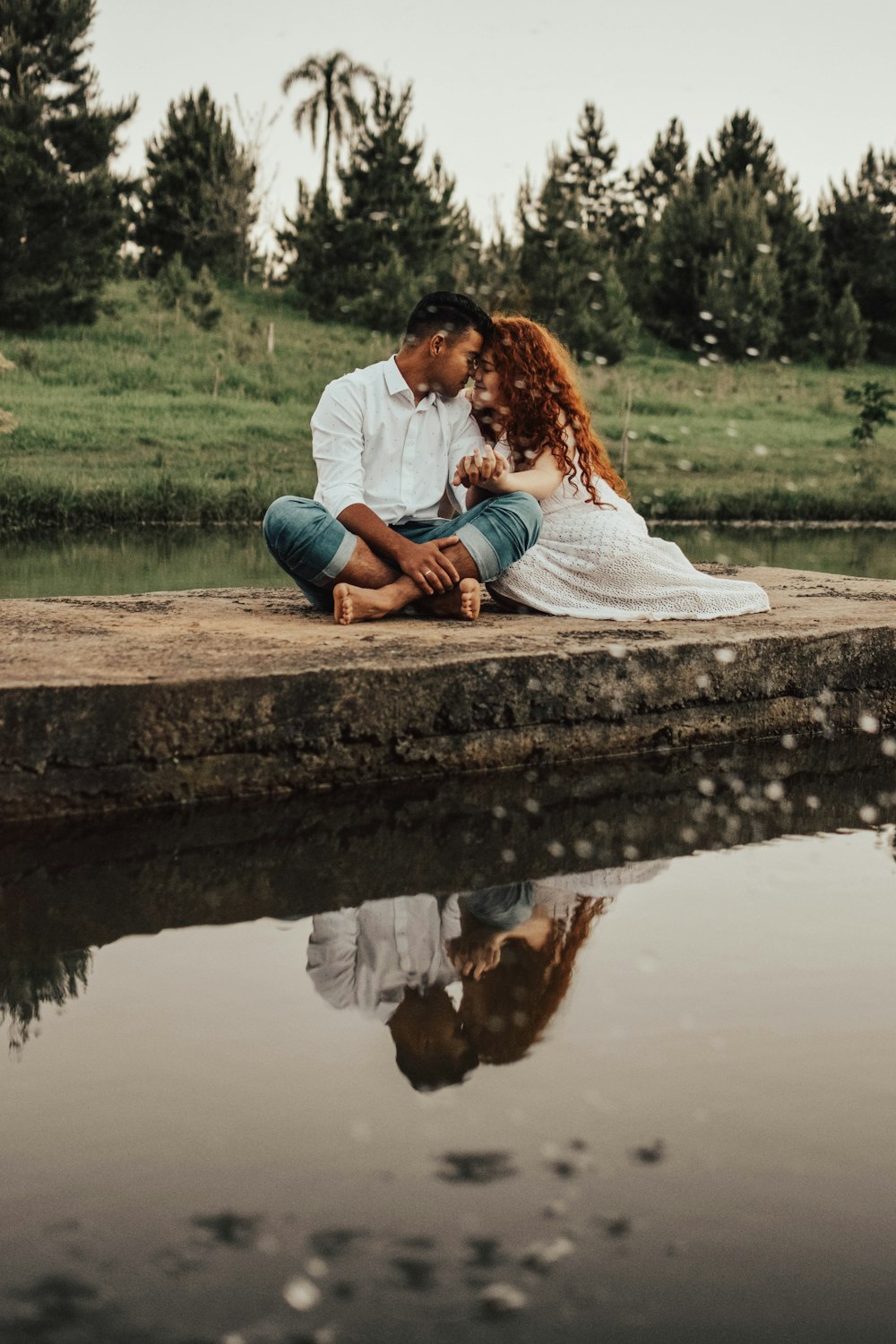 man and woman sitting while holding hands