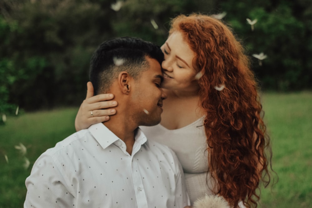 woman kissing man's forehead