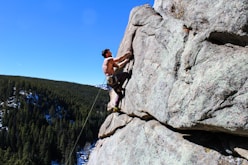 man rockclimbing at daytime
