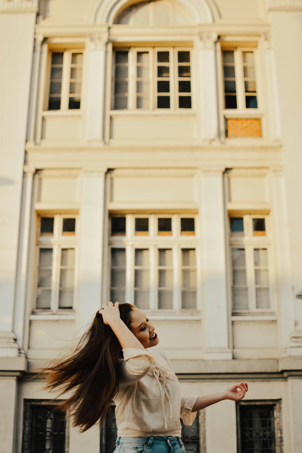 photography of woman combing her hair with her hands