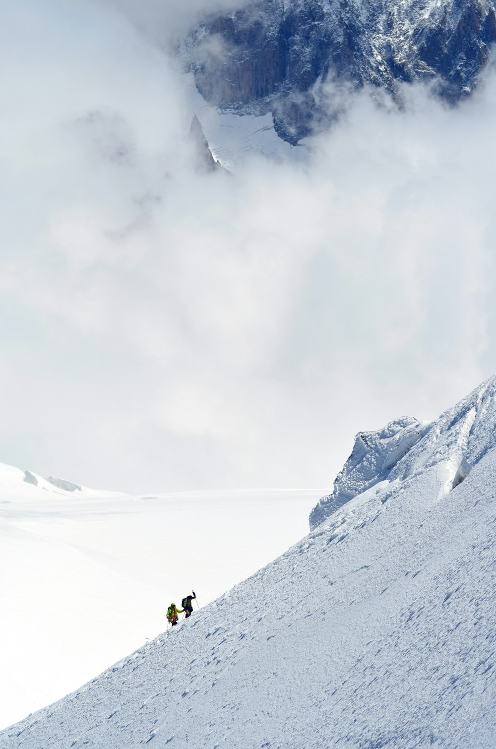 two person hiking on snow-capped mountain