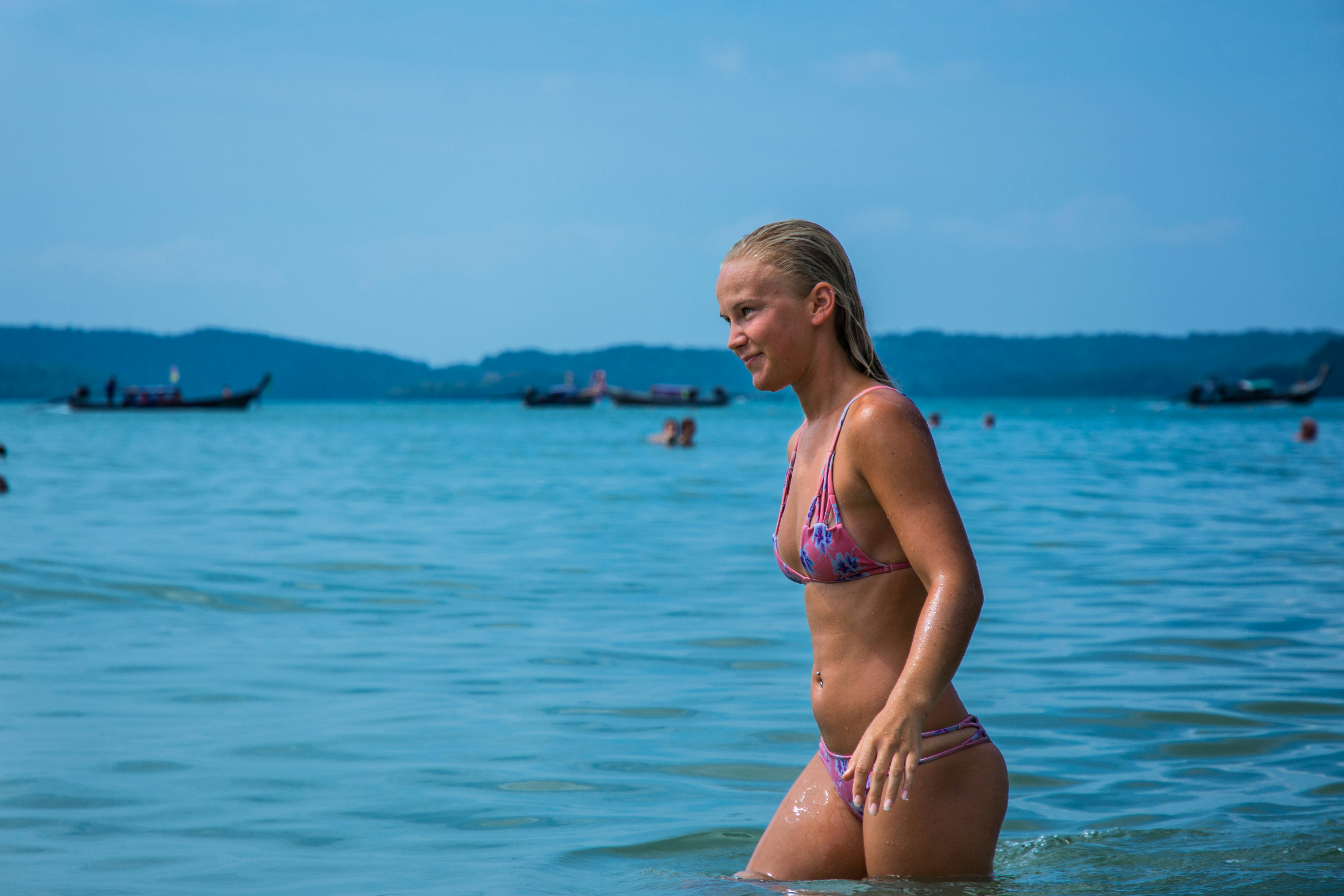 woman in bikini standing in water during daytime