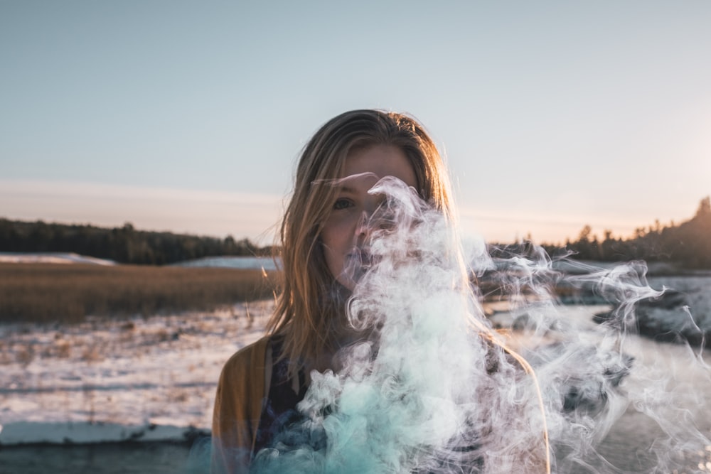 woman standing near white smoke