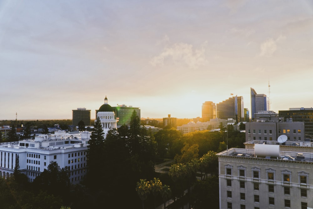 aerial photography of city with high-rise buildings under white and yellow sky during daytime