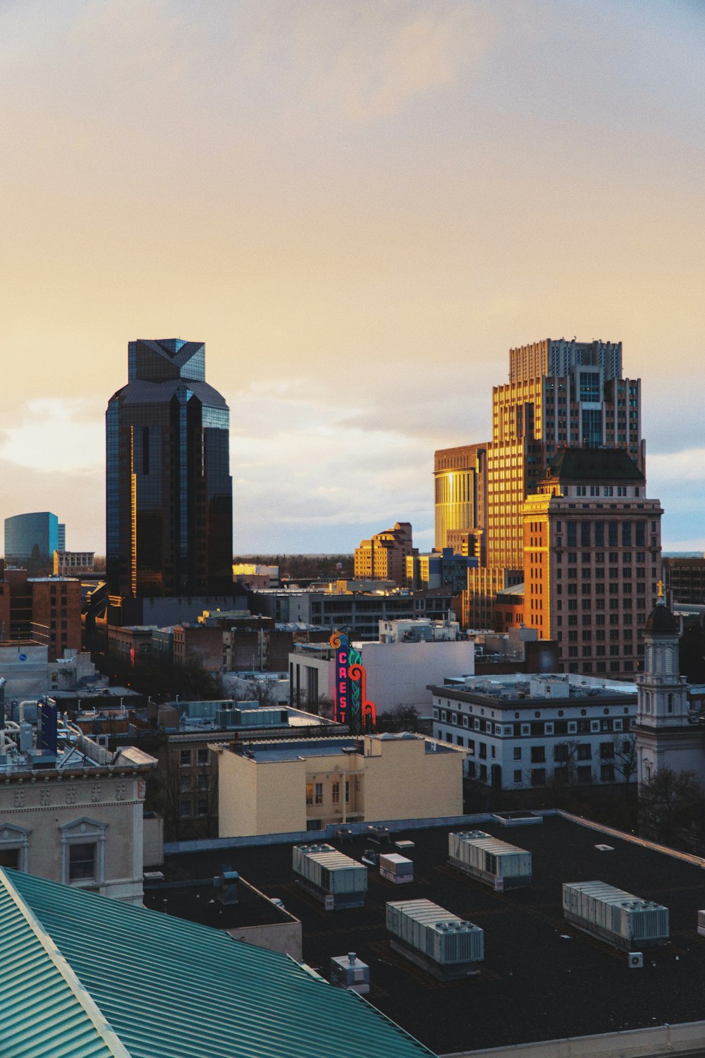 city with high-rise buildings under yellow sky during daytime