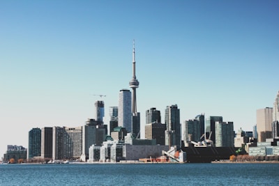 photo of high-rise buildings near body of calm water during daytime