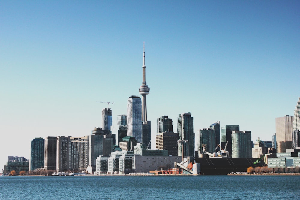 photo of high-rise buildings near body of calm water during daytime