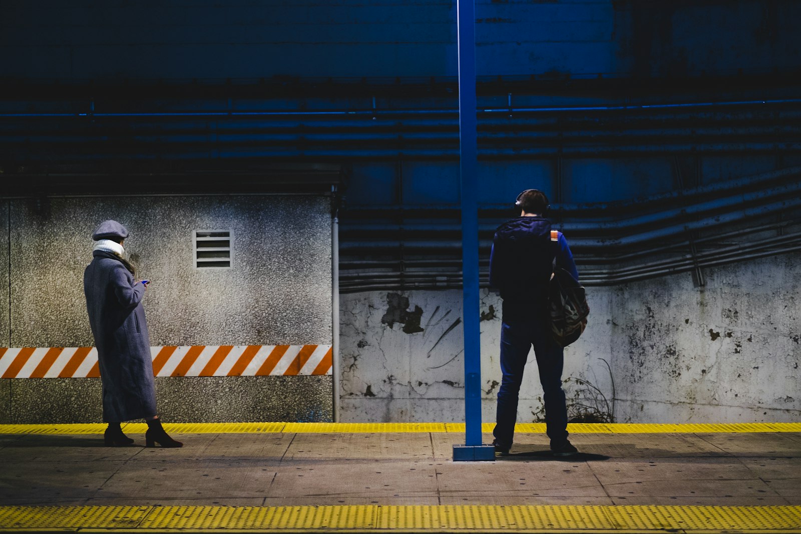 Fujifilm X-T1 + Fujifilm XF 50mm F2 R WR sample photo. Man standing near post photography