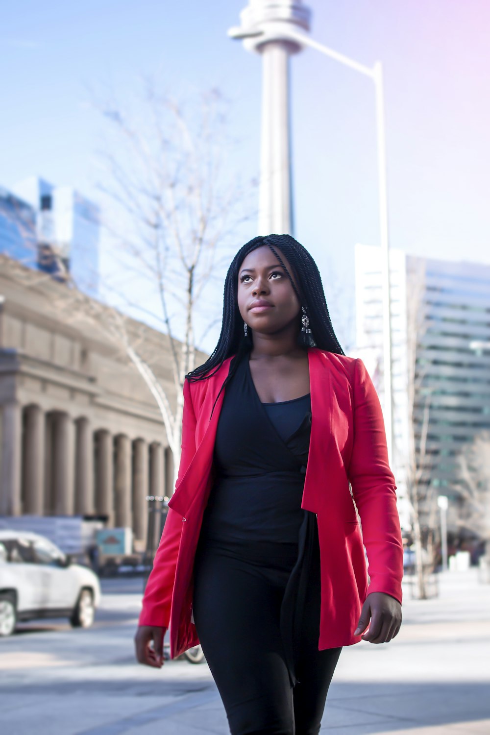 selective focus photography of woman wearing black V-neck shirt and pink cardigan while standing