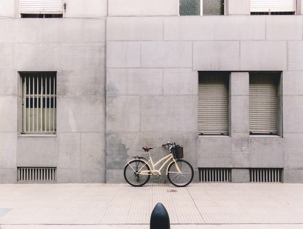 person taking photo of white parked bicycle