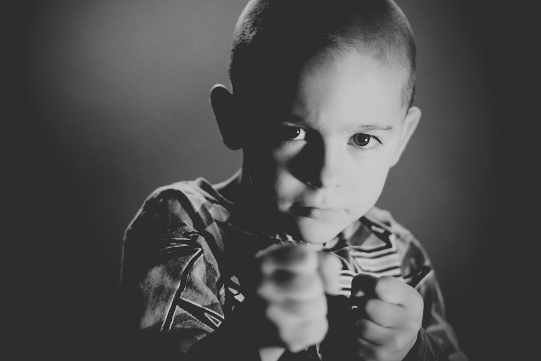 grayscale photo of boy wearing crew-neck top