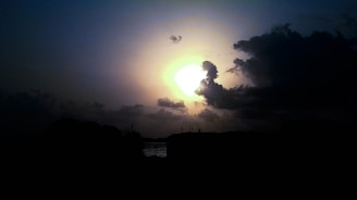 Cinematic still from a music video featuring danken against a dramatic sunset backdrop