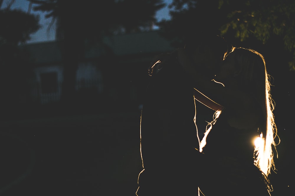 silhouette of man and woman kissing