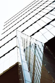Close-up photo of a modern museum exterior with sharp geometric shapes and glass reflections