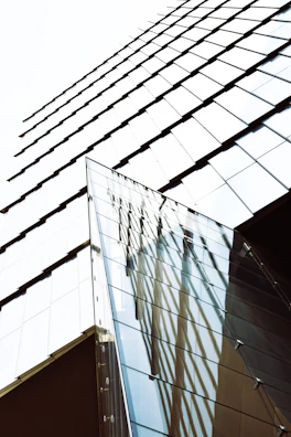 Close-up photo of a modern museum exterior with sharp geometric shapes and glass reflections