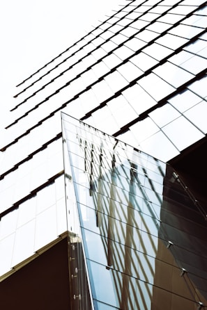 A finished modern building with clean lines and reflective glass, symbolizing the blend of innovation and craftsmanship.