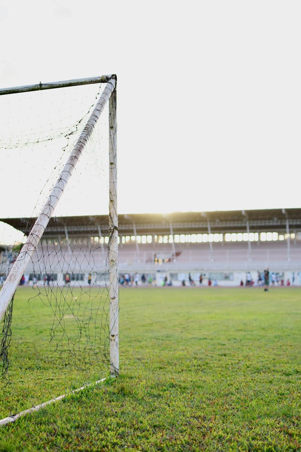 Rede de goleiro branco no campo de grama verde