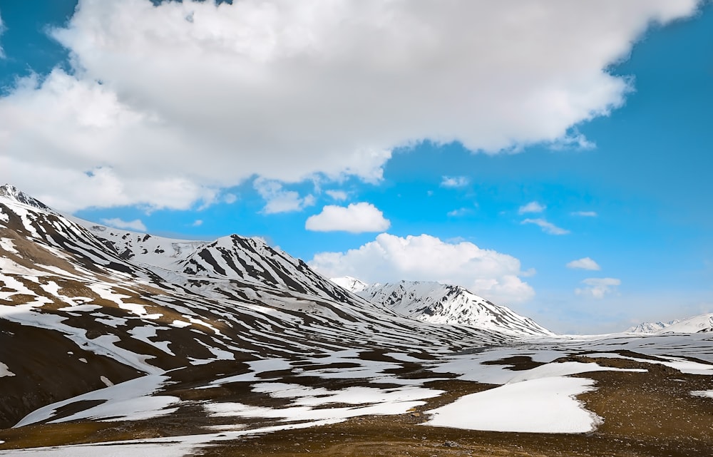 snowy mountain under white clouds