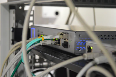 Close-up of high-tech networking equipment with cables and blinking indicators.