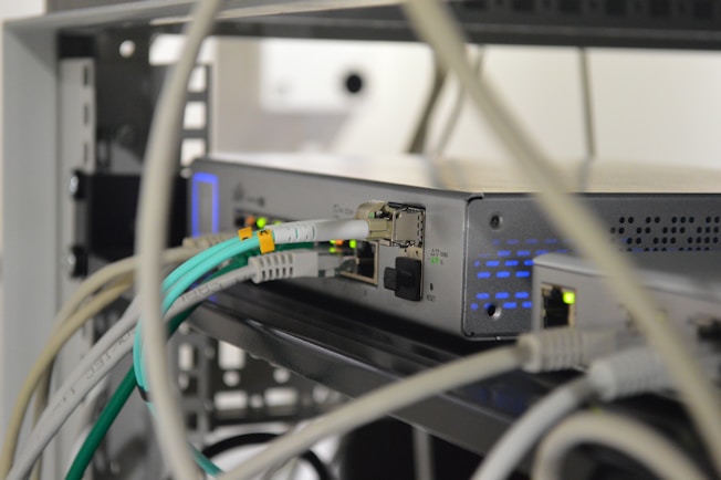 A professional technician configuring network equipment in a modern office environment.