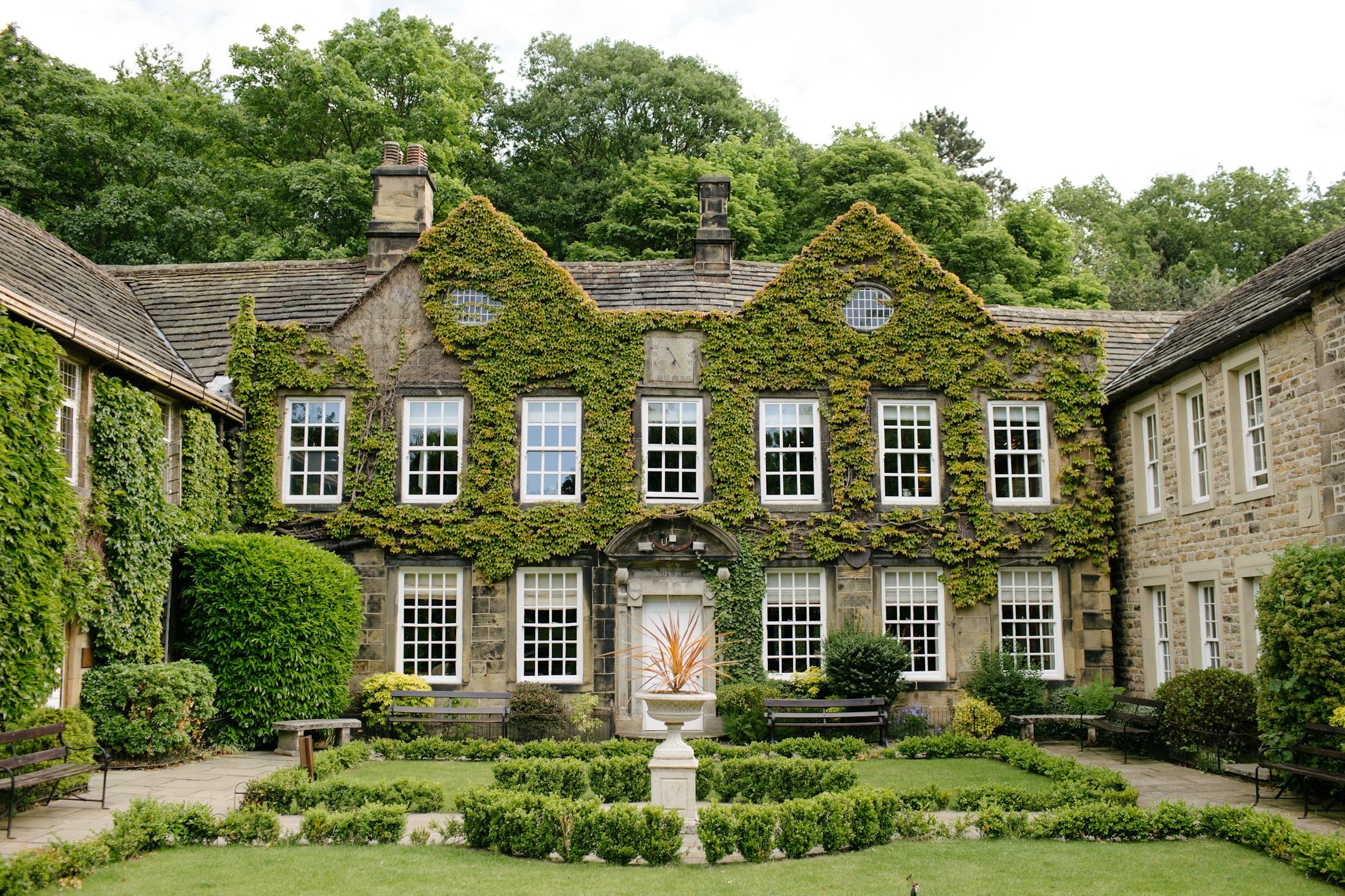 A heritage house held by mature landscape