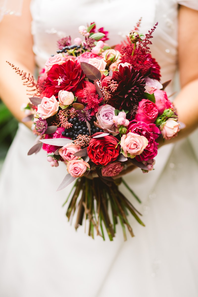Bridal bouquet with garden roses and dahlias in deep red and blush tones