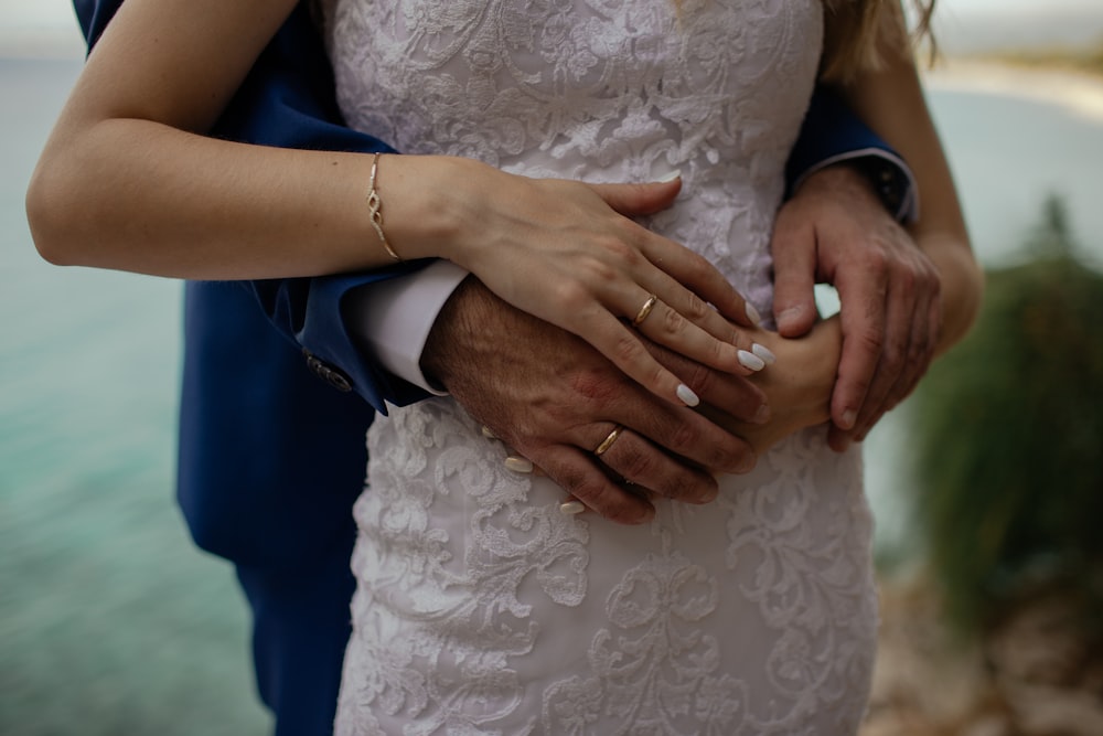 man wrapping hand around woman's waist