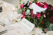 two wine glasses near flower arrangement
