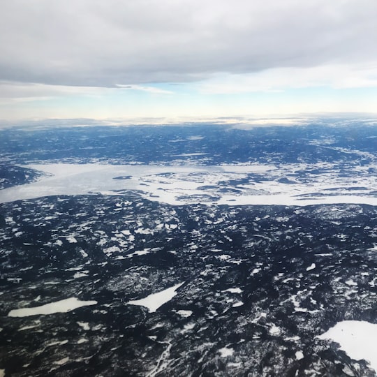 aerial view of snow covered mountains during daytime in Oslo Norway