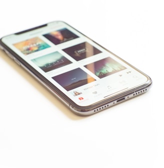 silver iPhone X on Apple Music menu