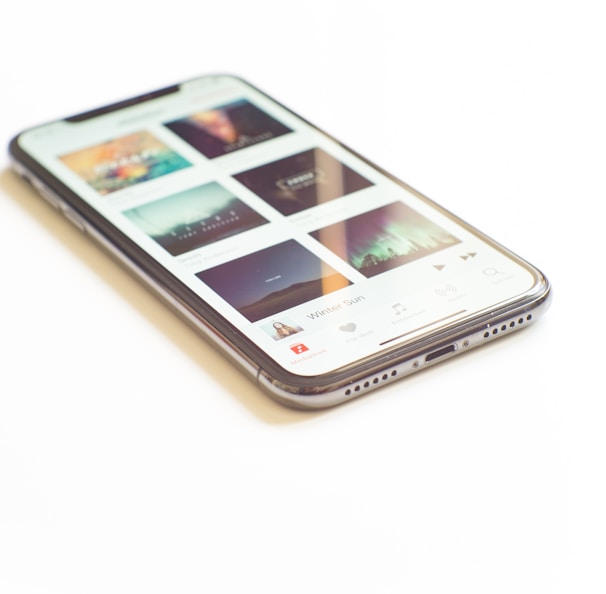 silver iPhone X on Apple Music menu