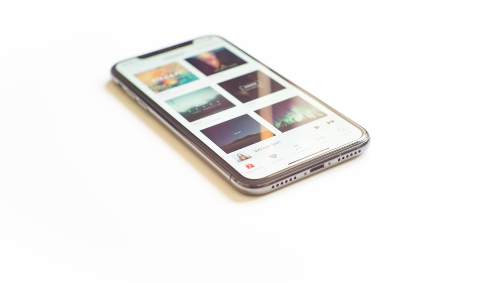 silver iPhone X on Apple Music menu