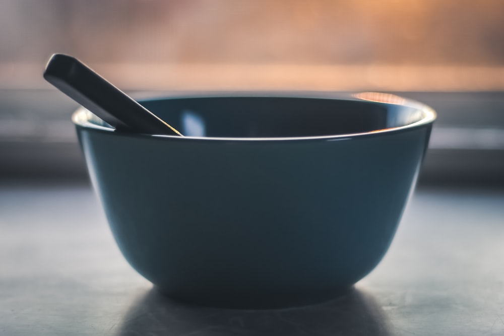 black ceramic bowl with silver spoon