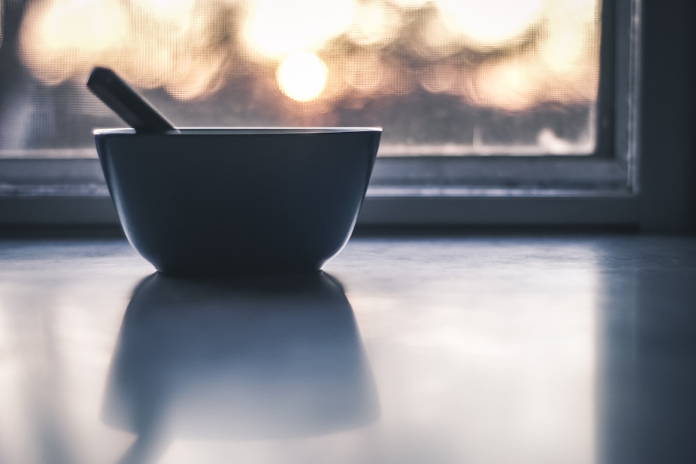 black ceramic bowl on white table