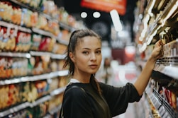woman selecting packed food on gondola