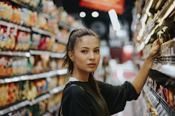 woman selecting packed food on gondola