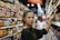 woman selecting packed food on gondola