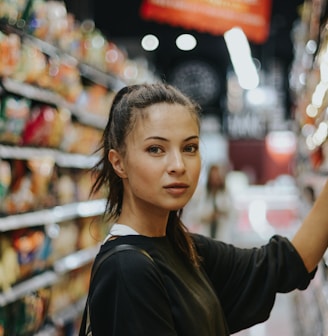 woman selecting packed food on gondola