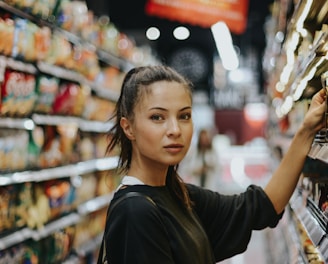 woman selecting packed food on gondola