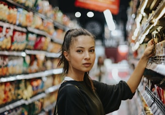 woman selecting packed food on gondola