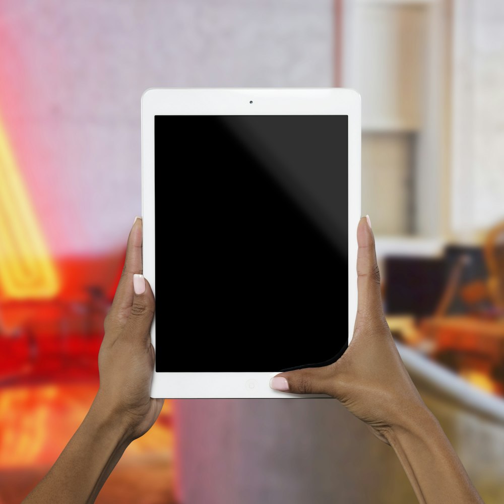person holding white iPad