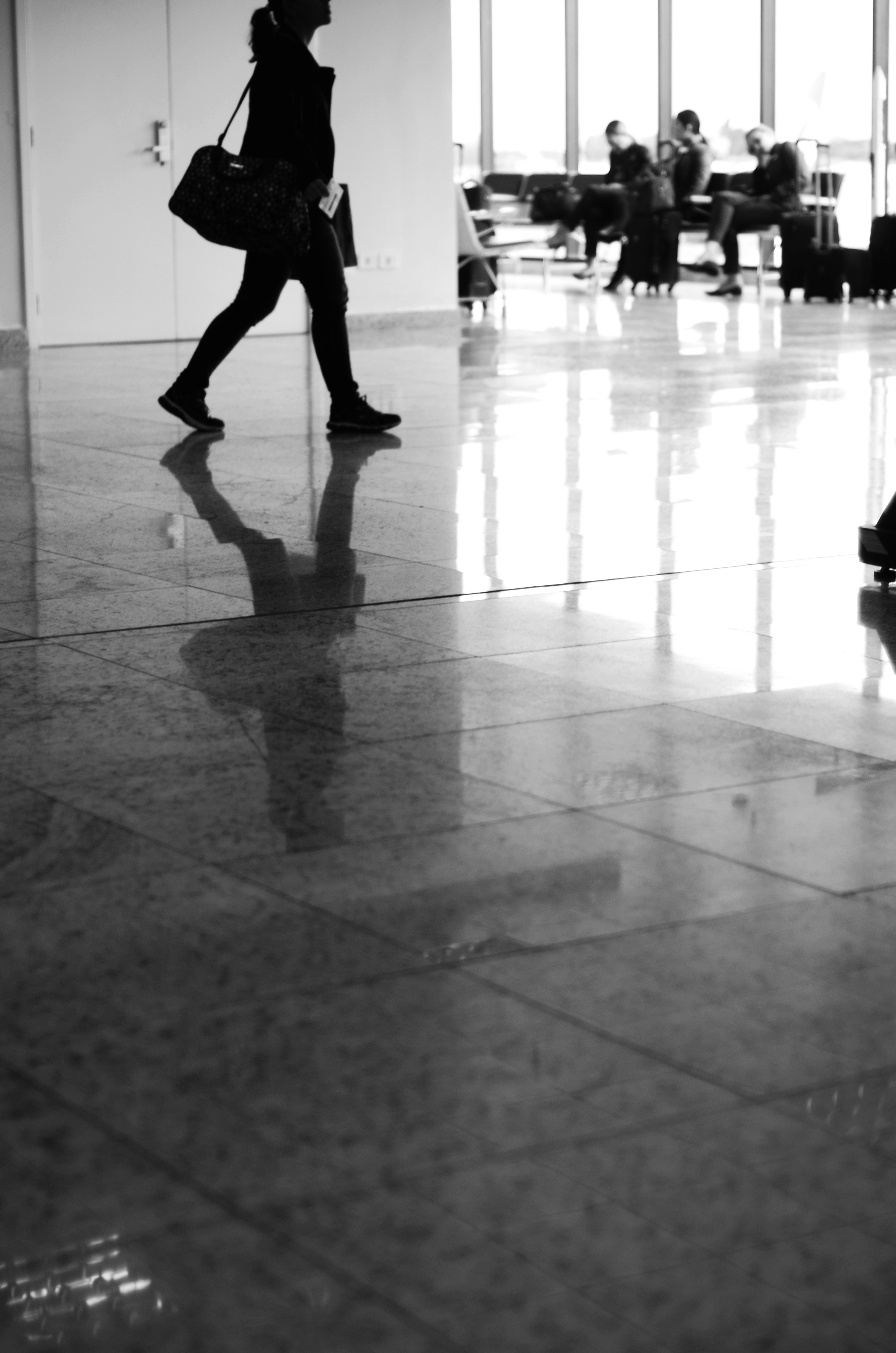 Modern airport terminal interior with business travelers