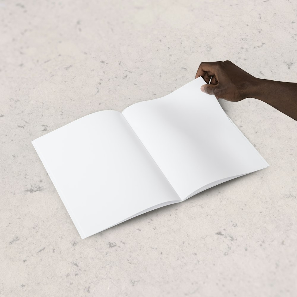 person holding blank book page