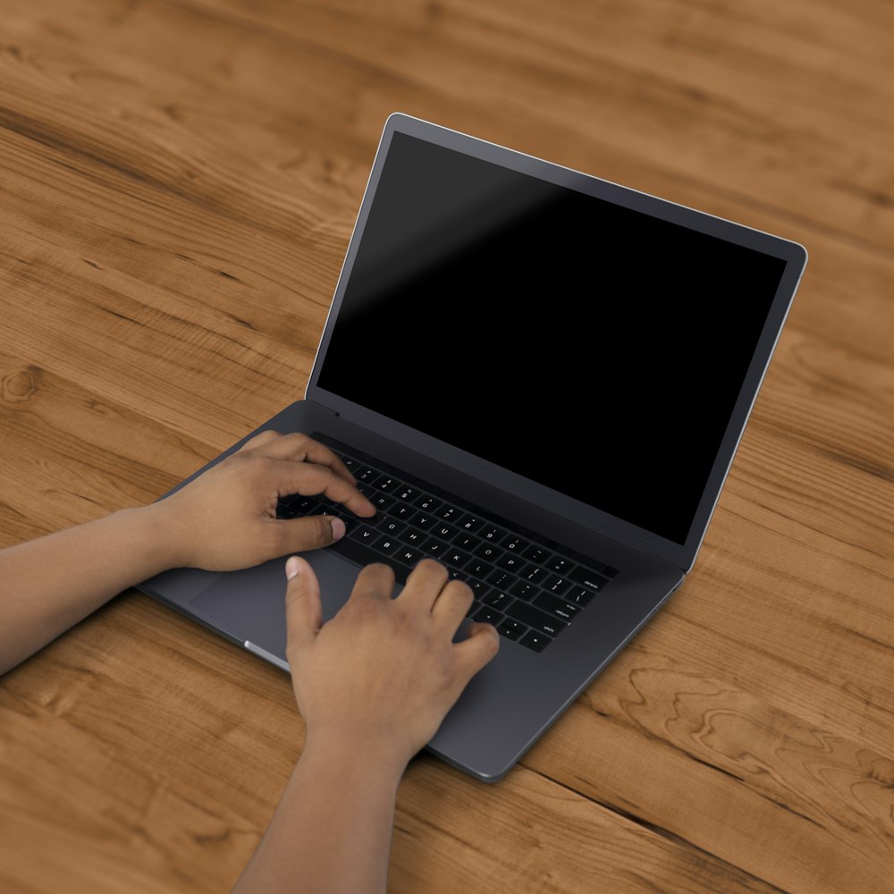 black laptop computer on brown surface