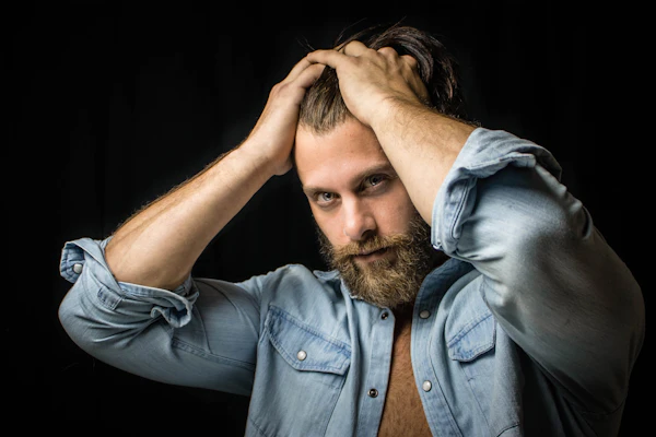 Portrait en studio d'un homme sur fond noir.