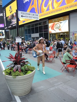 An artist performing in a lively urban setting.