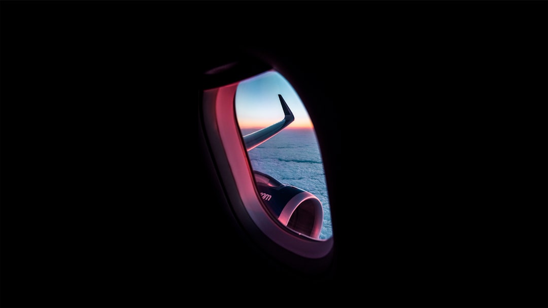 photograph of sea through airplane window, Aerial View of Sunset and Clouds