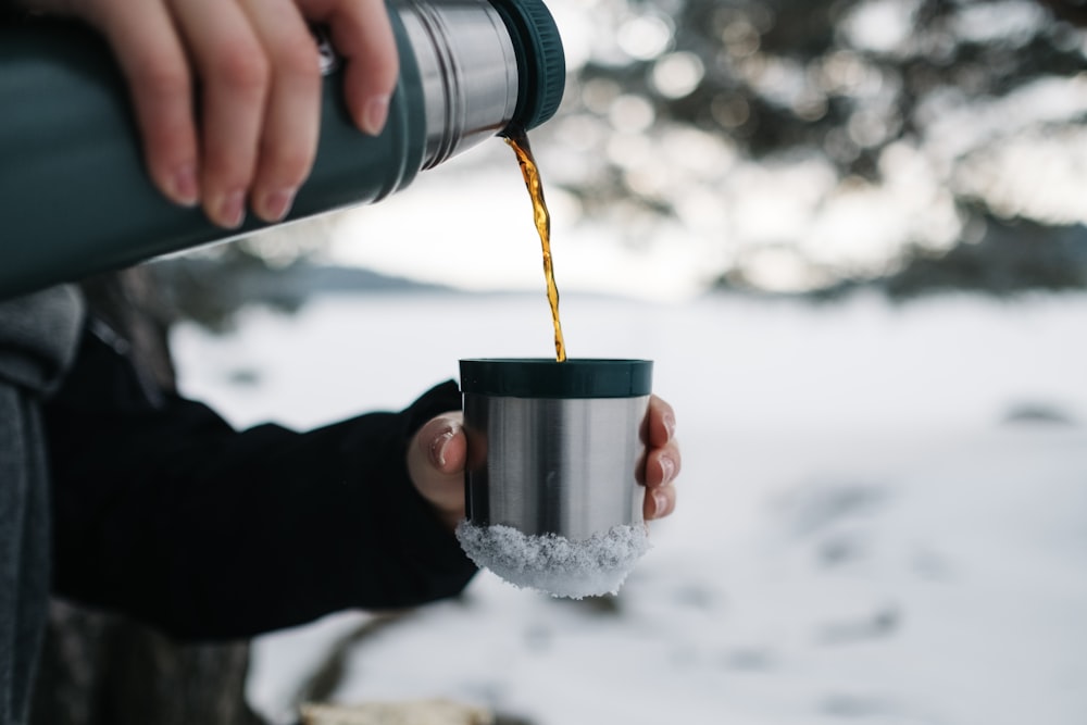 person pouring a mug