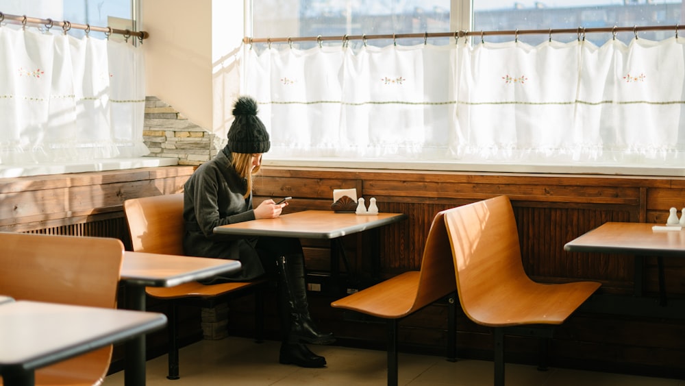 person sitting in front of brown wooden table